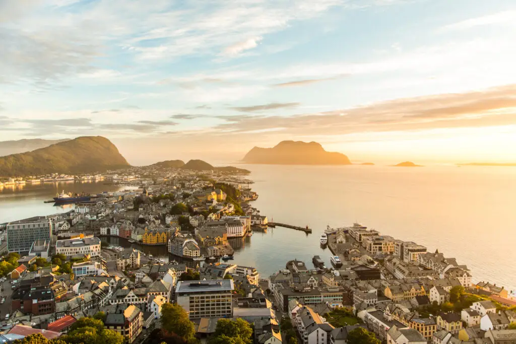 Aerial view of Alesund town at sunset, showcasing the picturesque architecture and coastal scenery in Norway, perfect for travel and tourism enthusiasts.