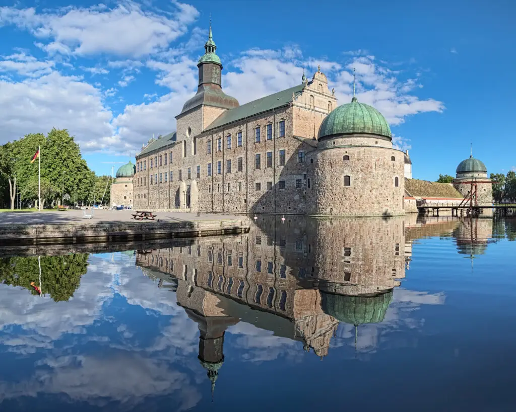 Vadstena Castle in Sweden, historic architecture from 1545 with reflection in water, a popular tourist destination in Vadstena city.