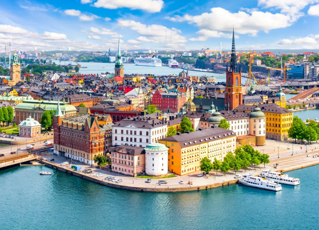 Aerial view of Stockholm's Gamla Stan, showcasing the colorful architecture and bustling waterfront, seen from the City Hall top.