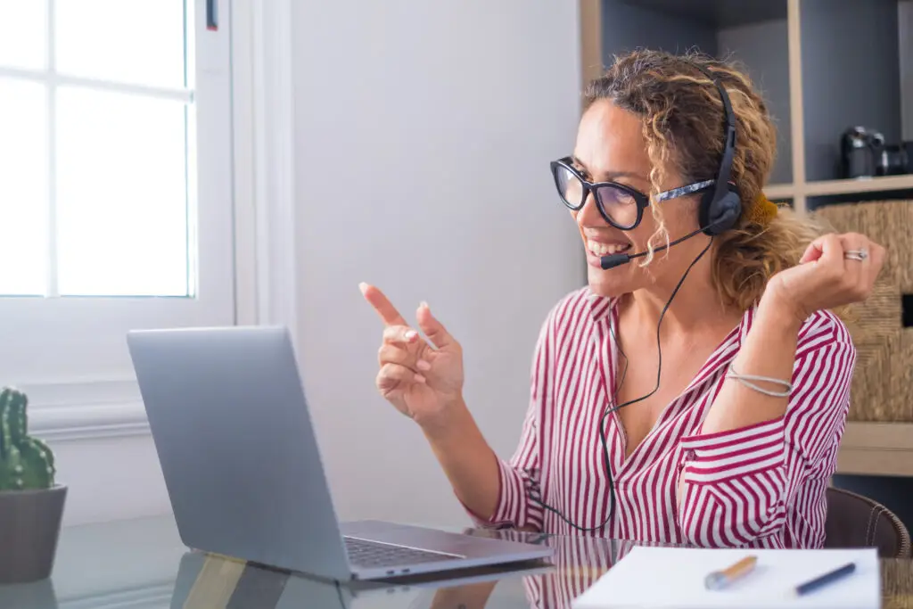 Attractive caucasian woman working as a virtual tour guide for Denmark Private Tours, engaging with clients from her home office