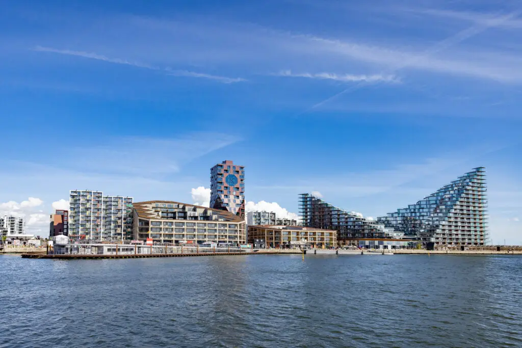 View of modern architectural landmarks at Aarhus old harbor, featuring innovative building designs under a bright blue sky, Denmark, Europe.