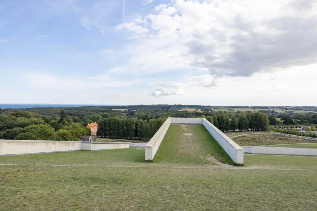 Aerial view of Moesgaard Museum with lush green landscape and architectural surrounds in Aarhus, Denmark, showcasing Scandinavian culture and history.