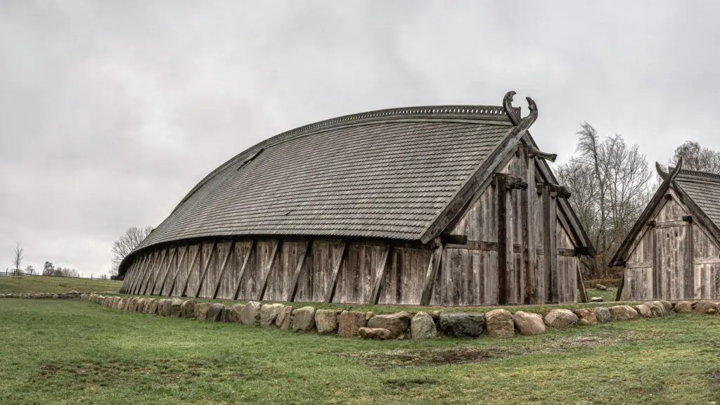 Historic King's Hall at Sagnlandet Lejre, Denmark showcasing traditional Viking architecture with intricate wooden structures and stone foundations.