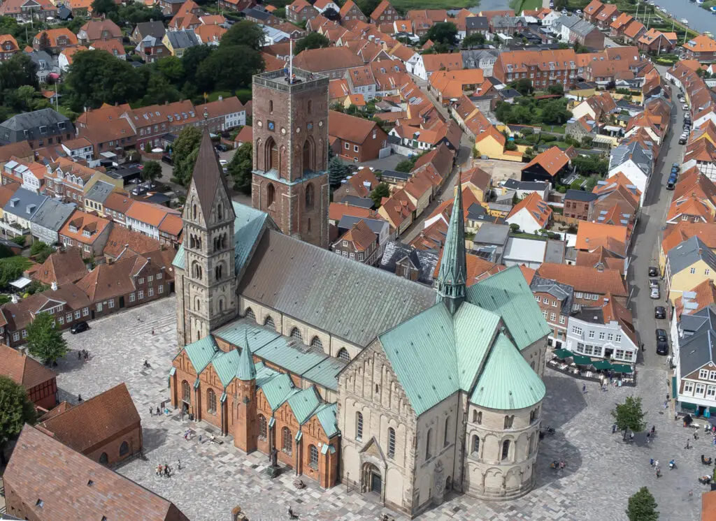 Aerial view of the Cathedral of Our Lady in Ribe, Denmark showcasing the historic architecture and surrounding quaint town streets.